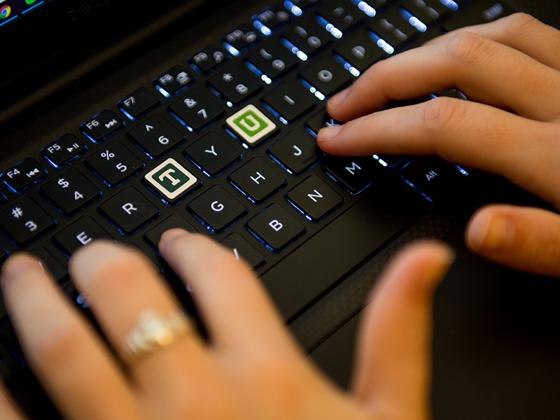 Hands typing on a computer keyboard